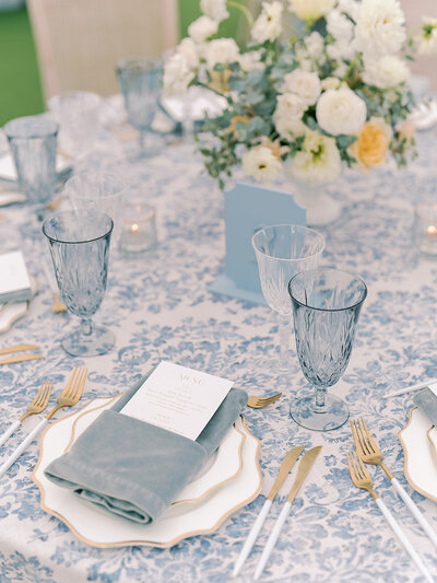Table setting with gold flatware and colorful florals