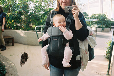 Suzy Brown photographing a family with her 35mm film camera.