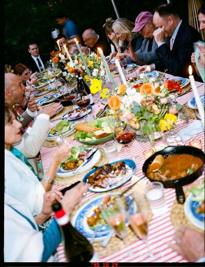 Rustic farm-to-table table arrangement with candles, fresh flowers, and seasonal dishes at a Los Angeles farm dinner.