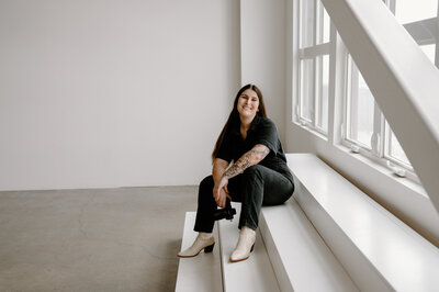 photographer sits on steps