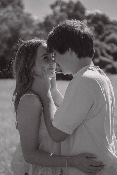 Romantic black-and-white portrait of a couple holding each other during a quiet moment outdoors — emotional couples photography by EC Photography in Alabama