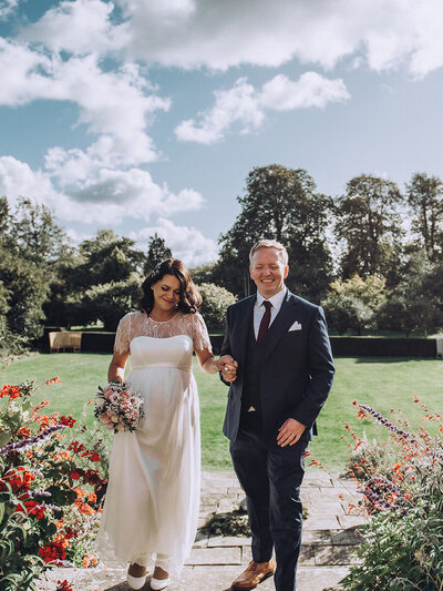 Bride and groom posing for portrait with white walls