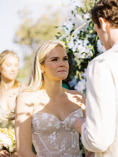 Bride holding back tears during her vows at Teeth of the Dog Golf Course wedding ceremony