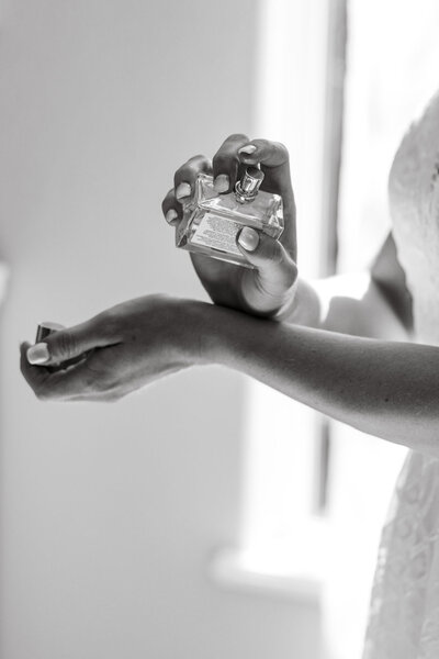 Bride putting perfume on taken by wedding photography Boise