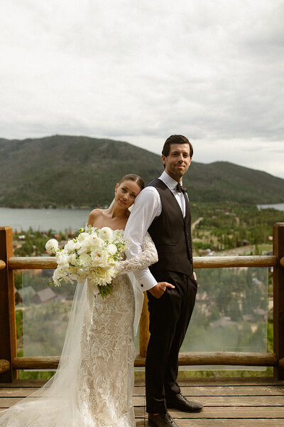 Courtney Steeves and her husband pose in front of the lake and mountains in Grand Lake Colorado
