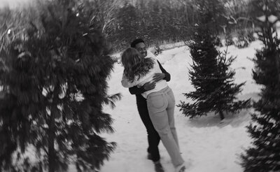 Couple dancing together in the snow during their winter Minnesota engagement session. Bride and groom are posing for their portraits during their intimate elopement in northern Colorado. Captured by a Minnesota based wedding and elopement photographer.