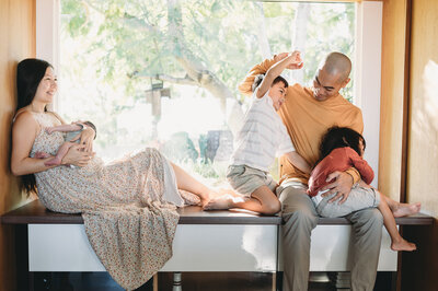 family of five playing in a window