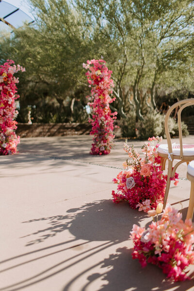 Wedding flowers at Desert Botanical Garden Phoenix features bougainvillea floral arrangements and flower arch designed by Snapdragon Bloom Bar