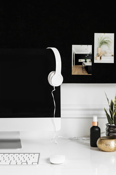 headphones hanging on a mac computer