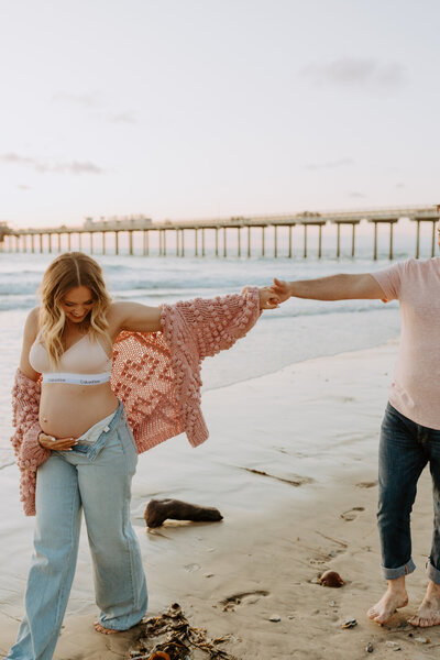 Natural Candid Documentary Family Maternity Baby Pregnancy Announcement Photo shoot at La Jolla Windansea beach at sunset - Couples Mom and Dad San Diego Maternity Photographer