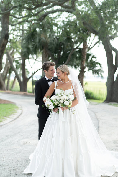 Wedding portrait under oak trees at Lowndes Grove in Charleston, SC