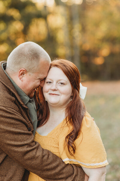 Photographer in Blacksburg, Virginia, Melena Lawson and her husband standing in a field. 