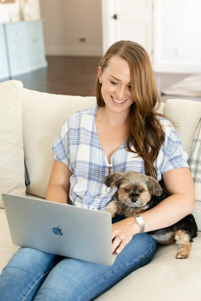 Megan sitting on the sofa with her dog