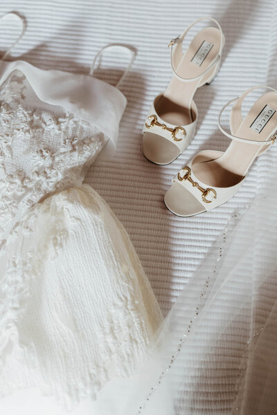 Details of a wedding dress and shoes.