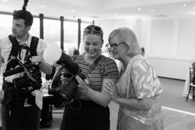 Millers Photo and Film Photographer showing her images to guest