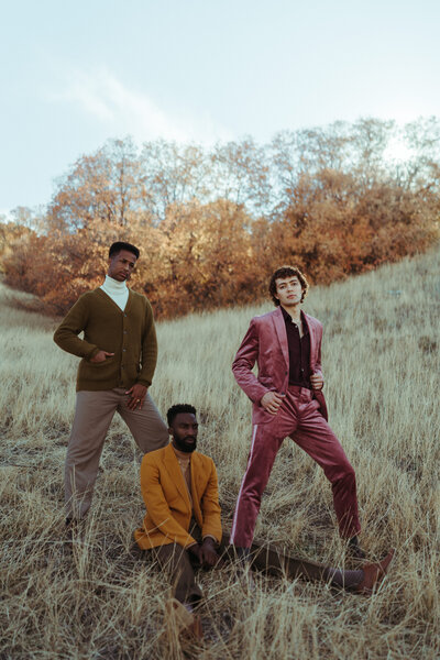 three men standing in a field