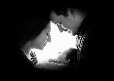 Black and white images of new mom & dad with newborn baby boy