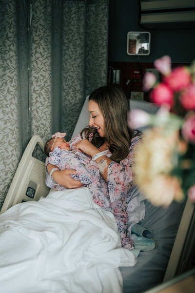 family of 5 laying on grass together