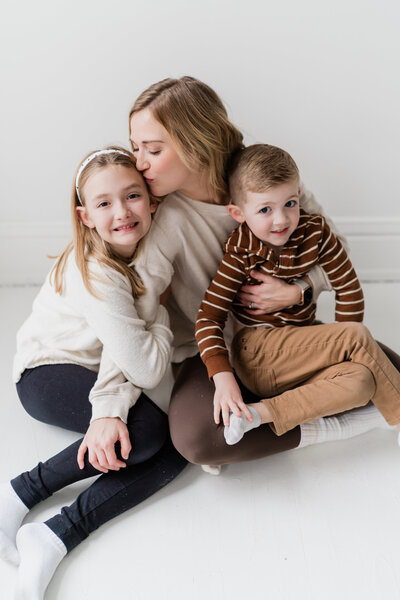 playful family picture mom with her two kids