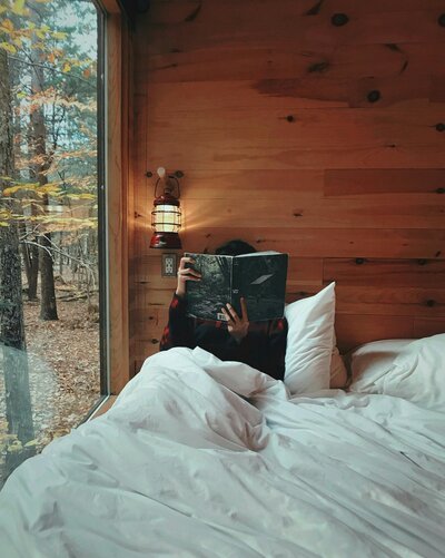 Woman reading a book in bed