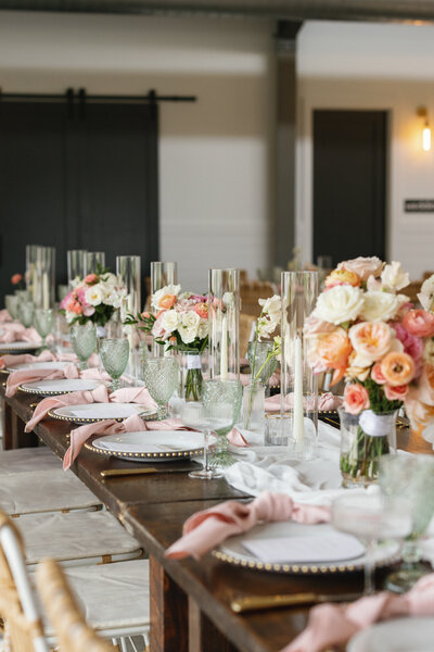 Sophisticated wedding floral arrangements and table decor in soft blush and peach tones, styled for elevated Central Texas events.