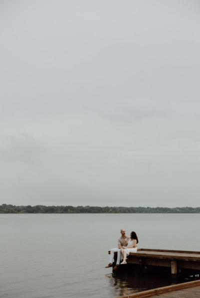 couple embraces on dock in texas for couples portraits