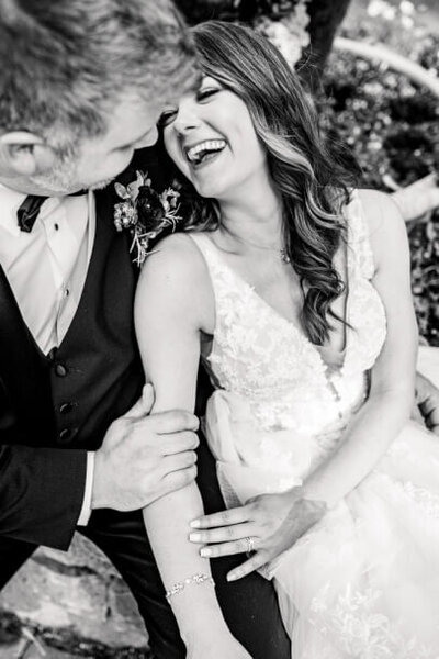 black and white photo of bride and groom laughing at the club at hillbrook captured by cleveland wedding photographers