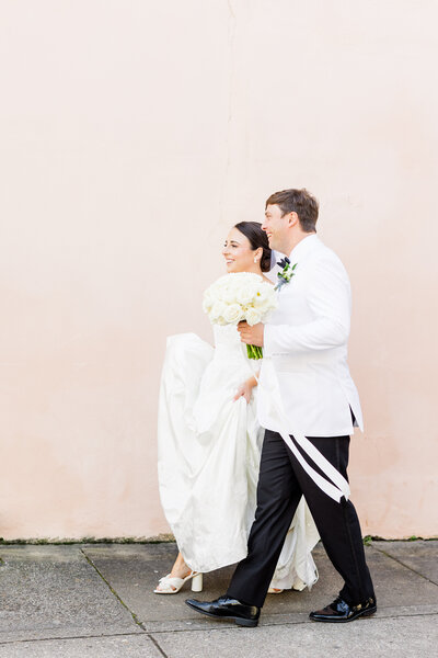 bride and groom walking on chalmers street in downtown Charleston