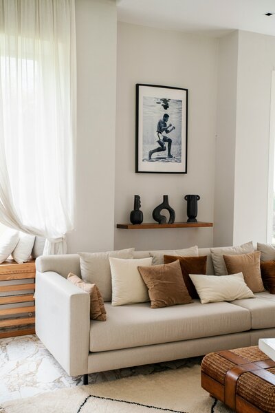 Living room with couch that has decorative pillows and art hanging 