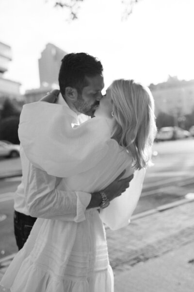 Husband and wife kiss and embrace in Tribeca, New York