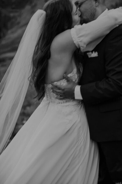 Bride and groom kiss in the Colorado mountains