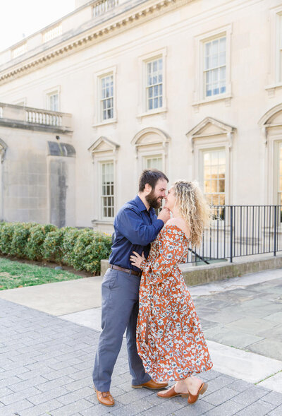 Couple leaning in for a kiss behind the Virginia Museum of Fine Arts in Richmond, Virginia. Captured by Bethany Aubre Photography.