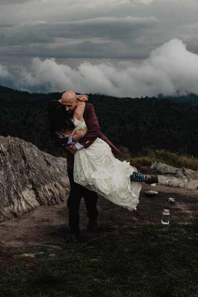 Couple having fun first dance on top of mountain in North Carolina elopement
