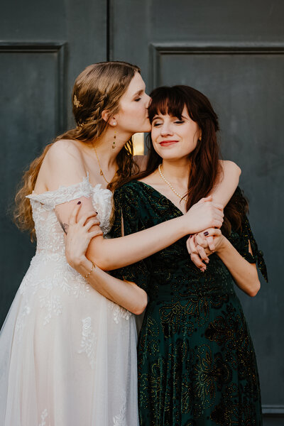 Couple hugging by a mountain