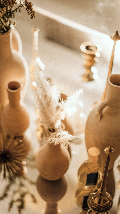 dried flowers and pots on the table