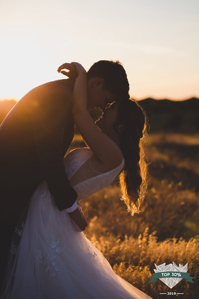 Bride and groom hugging in the sunset