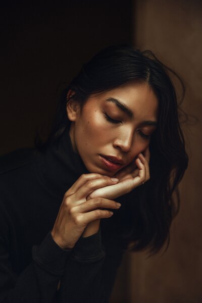 Black hair, women, black shirt, head in hand