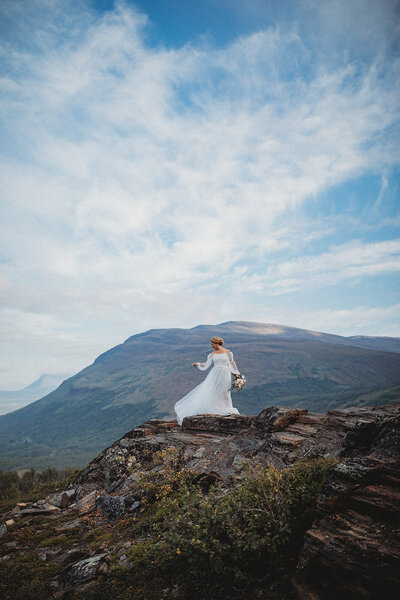 Bride on mountain top in Sweden's Arctic