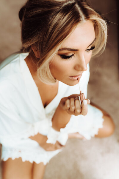 Wedding Photography, close up of bride putting on her lip gloss