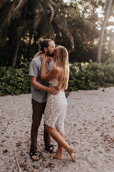 Hawaii Destination Wedding Photographer captures groom kissing brides