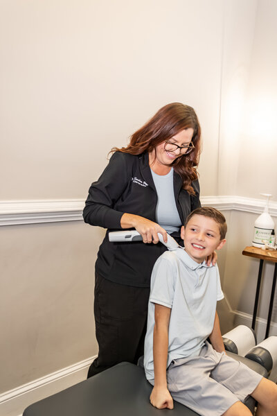 Dr. Buffkin massaging a child's shoulder.