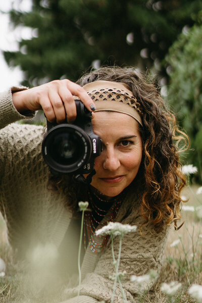 Lifestyle photographer Ashley Kaplan hold camera in front of her face