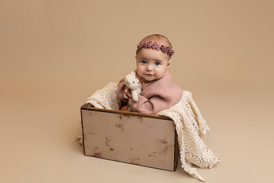 Beautiful baby boy wrapped in a hand knitted  green wrap with matching bonnet.