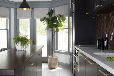 A new kitchen layout in a Westwood home featuring dark grey kitchen cabinets, designed by a top kitchen designer in Boston for a sleek, modern look.