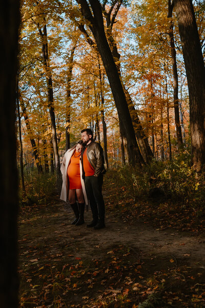 Husband and wife in forest for Fall maternity session in Wheaton, IL