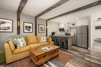 Living room with yellow couch and cozy decor
