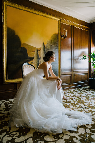 Bride sitting in hotel for wedding photo