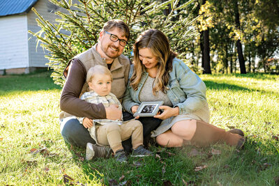 family with toddler boy and ultrasound image