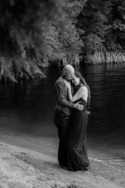 A couple in a tender hug by the lake, for their wedding photography