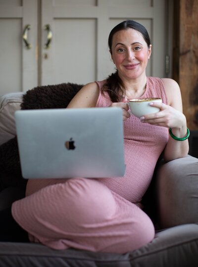 Mariella holding a cup of tea and smiling